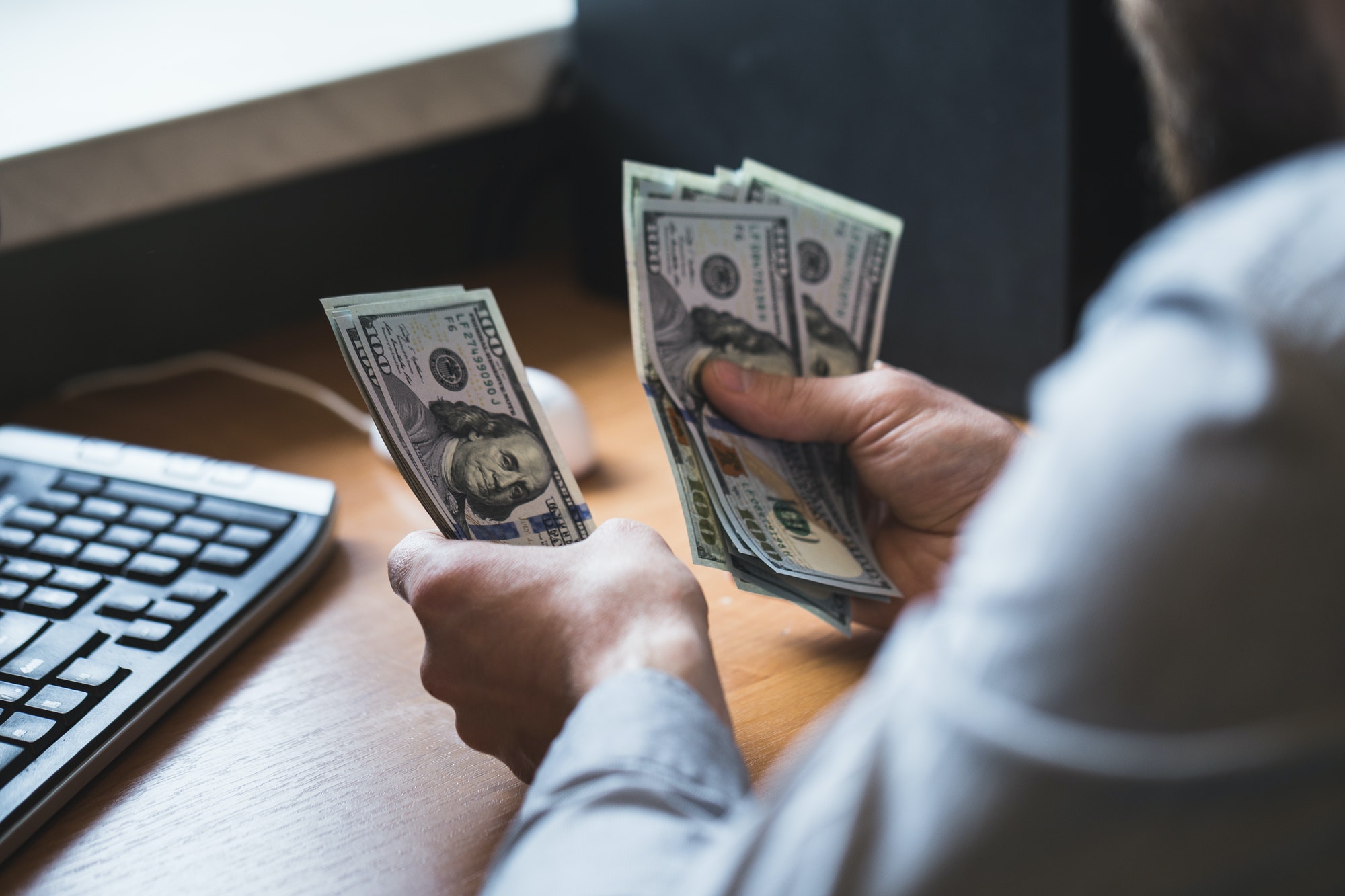 businessman-is-counting-dollars-banknotes-business-and-financial-background.jpg